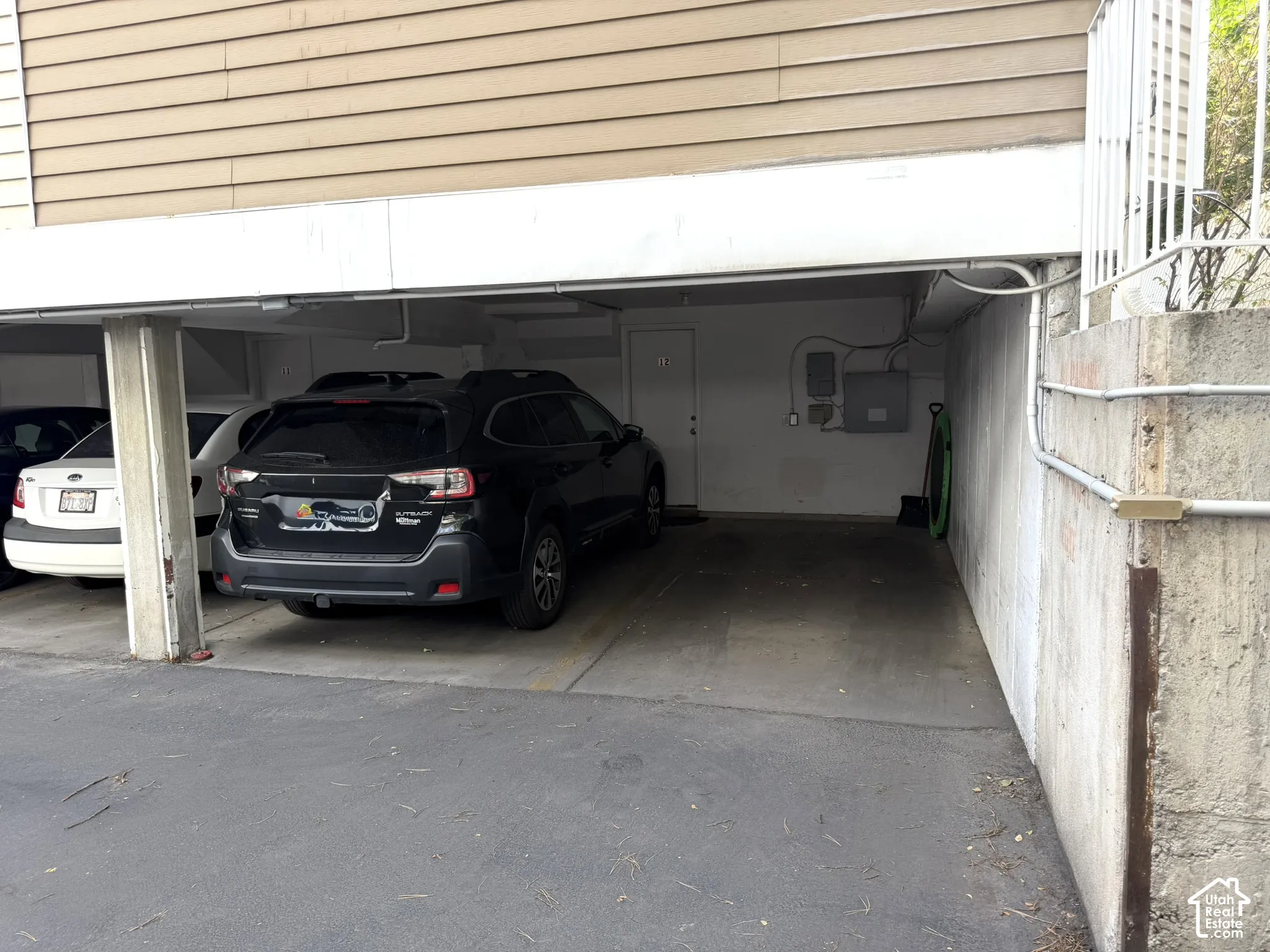 2 covered parking spots under unit with basement entrance.