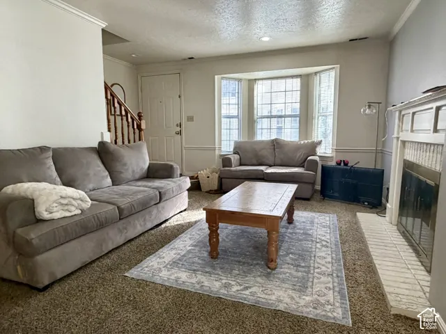 Living area with bay window, and a built-in fireplace.