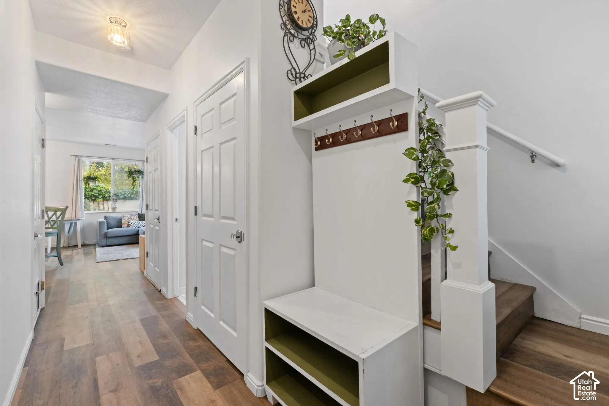 Wood-finish flooring throughout, with a built-in storage bench and coat rack