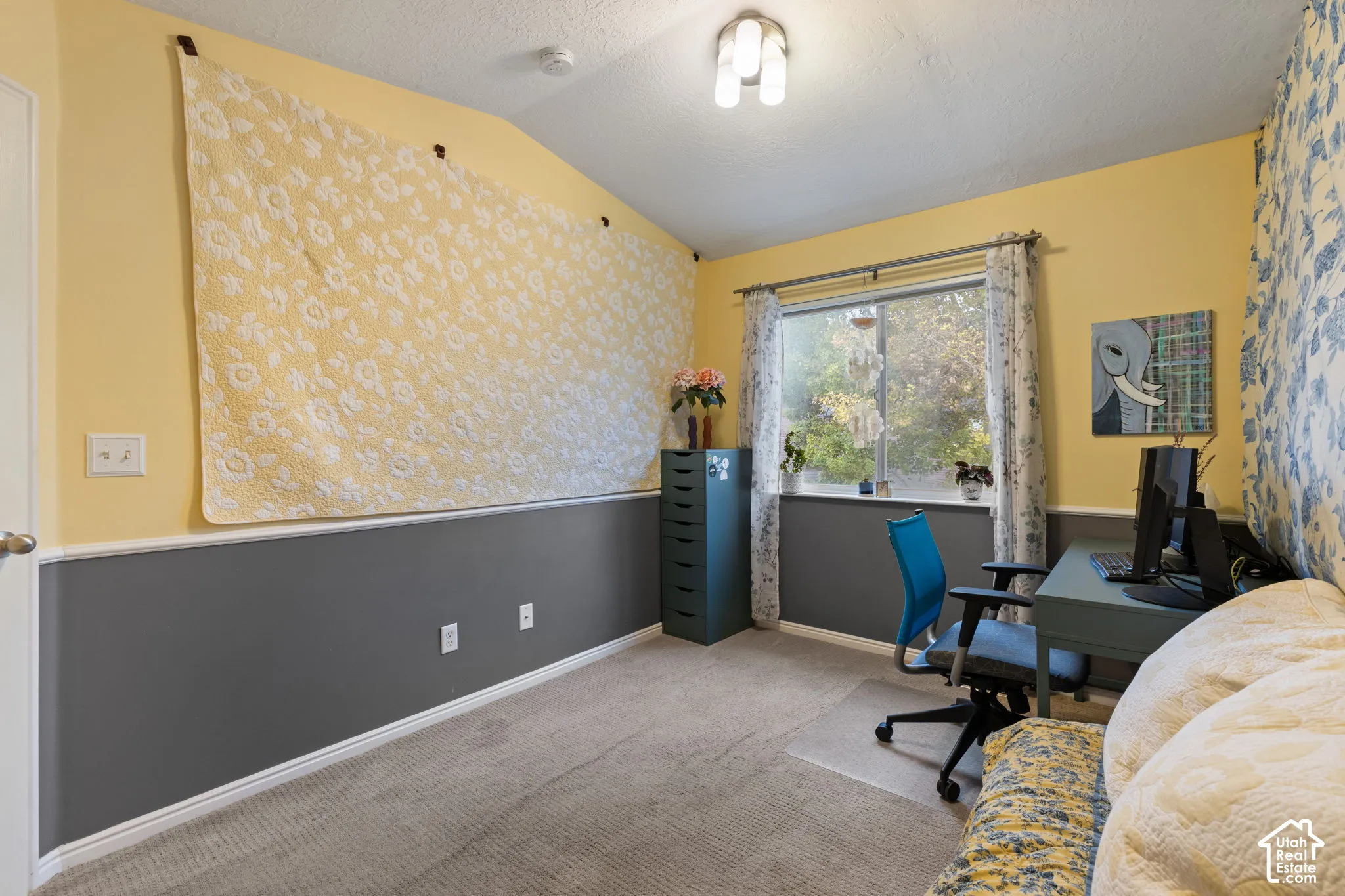 Carpeted flooring, window with natural light, textured ceiling, built-in lighting fixture, decorative wall treatment