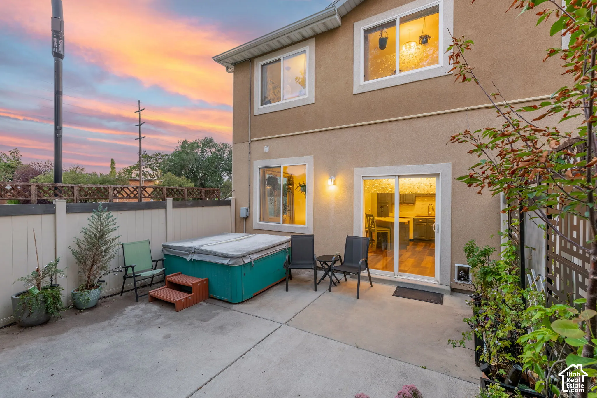 Concrete patio with an integrated hot tub and privacy fencing