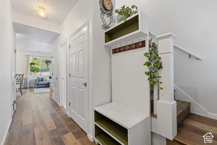 Wood-finish flooring throughout, with a built-in storage bench and coat rack
