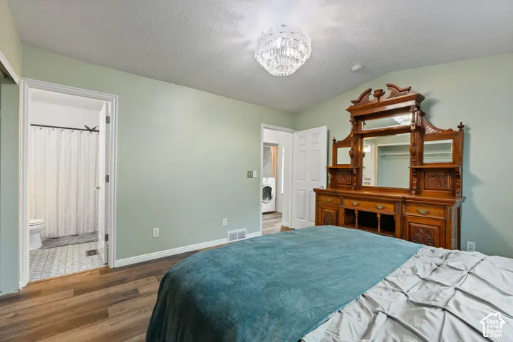 Wood-finish flooring throughout, with a crystal chandelier and light green wall paint