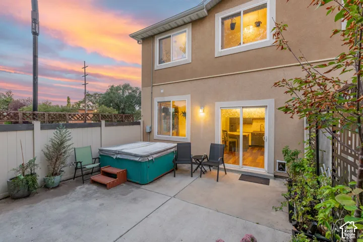 Concrete patio with an integrated hot tub and privacy fencing