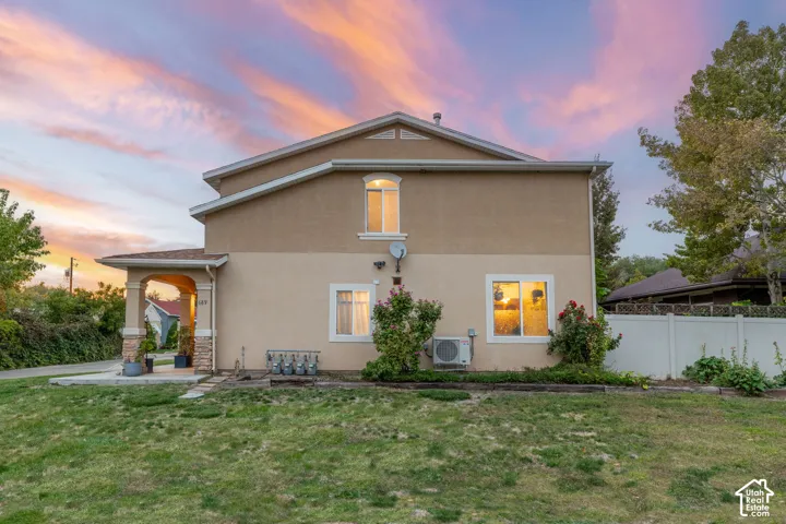 Stucco exterior with an arched entry, stone veneer columns, and a covered porch