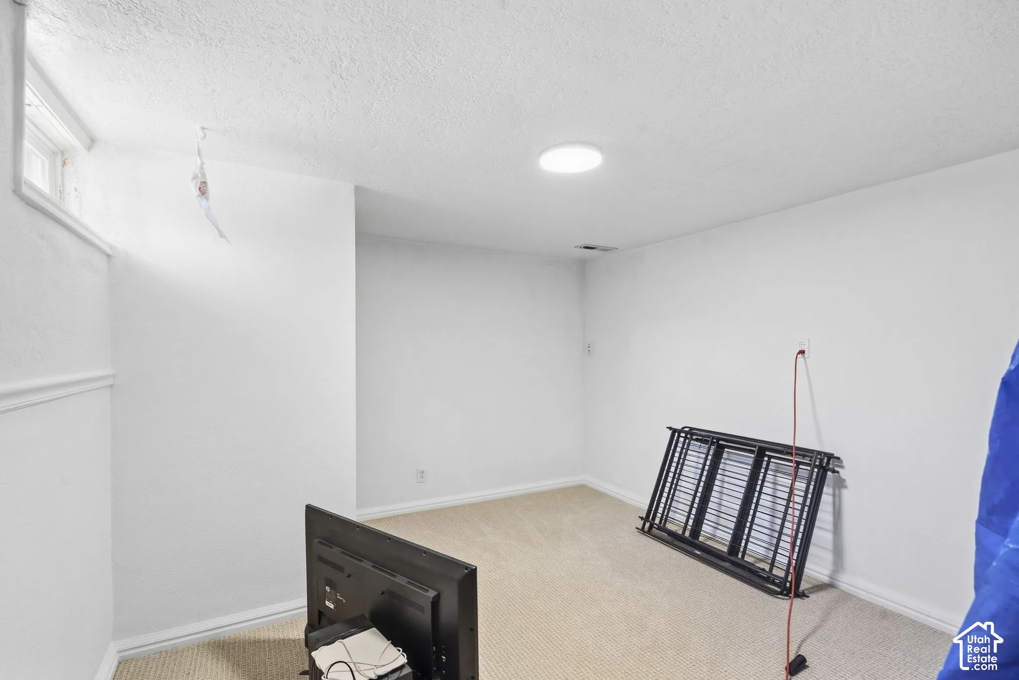 Carpeted flooring, white walls, recessed ceiling lighting, and a horizontal window