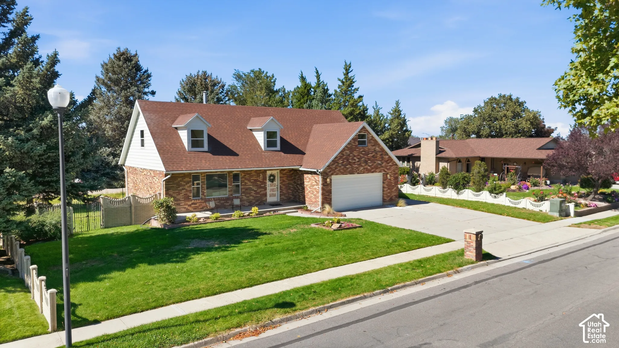 Brick and siding exterior with a shingle roof and two dormer windows