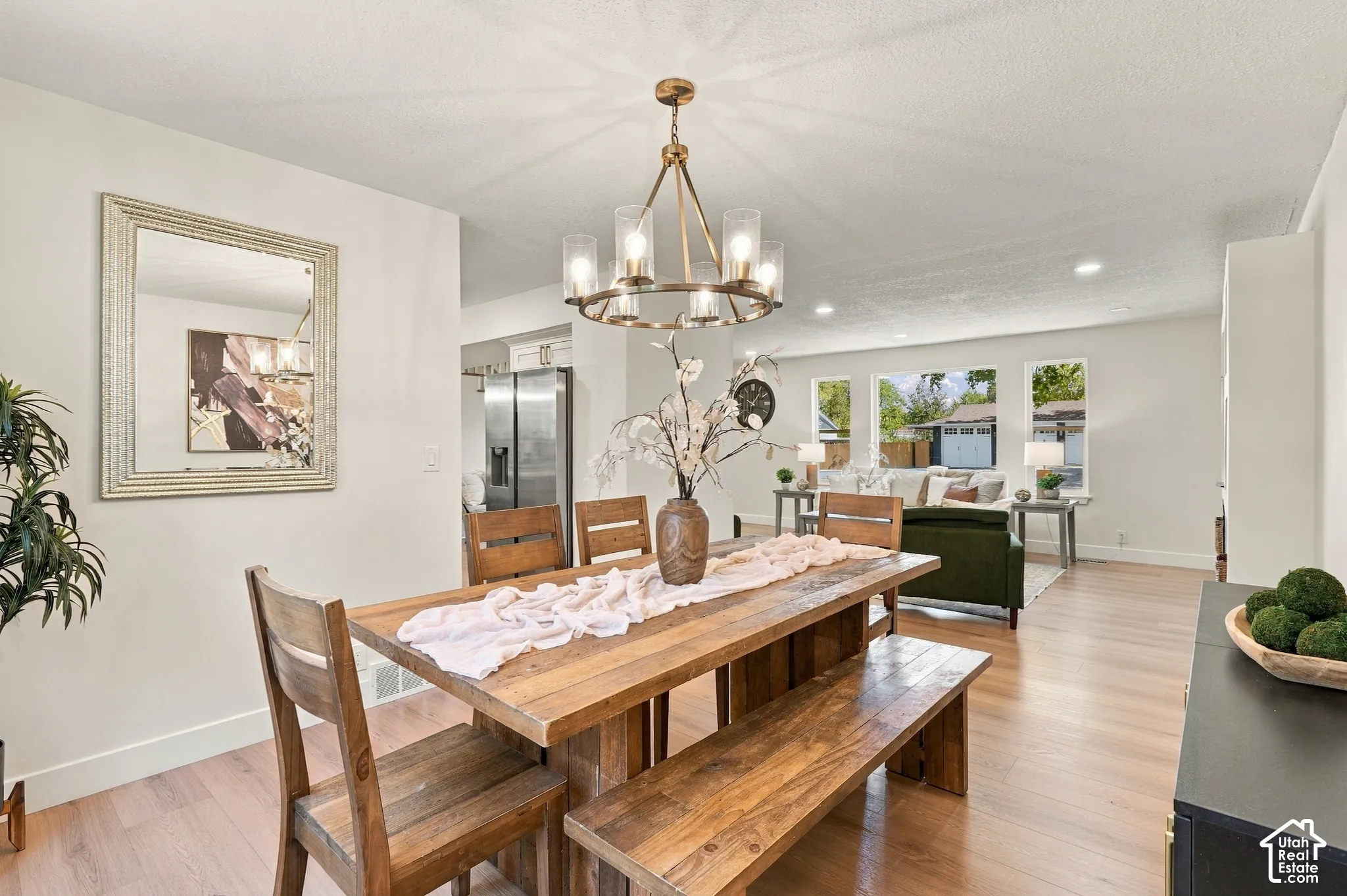 Open concept living space featuring wood-finish flooring, recessed lighting, and a contemporary chandelier
