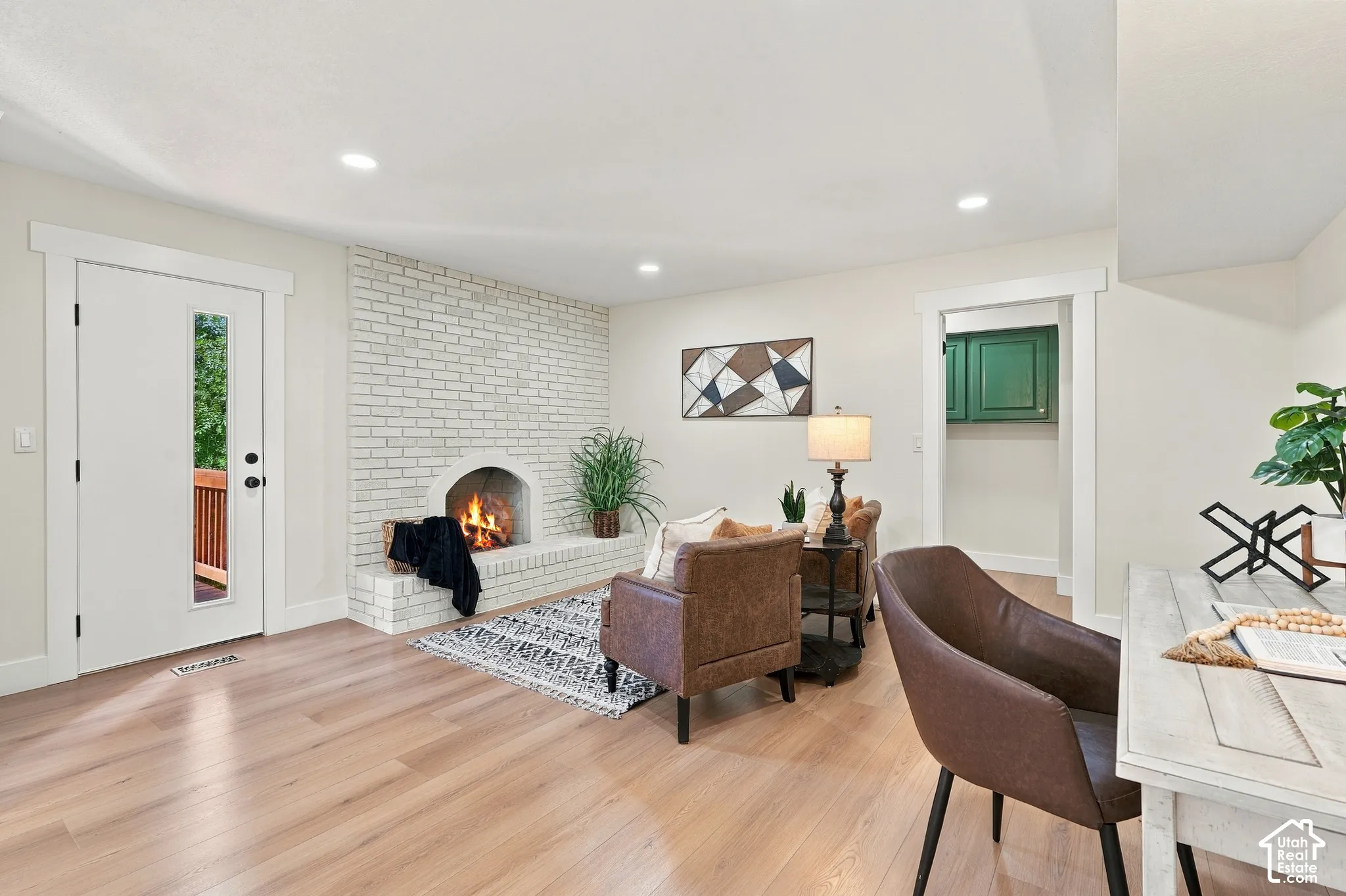 Light wood-finish flooring and a flex space could be sitting area, semi formal dining room, or den.