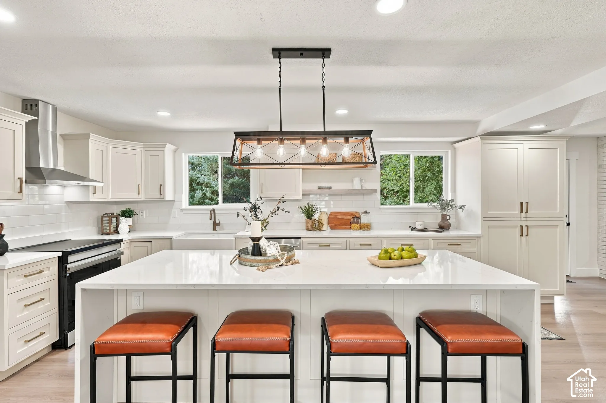 Expansive kitchen island with a waterfall marble island.