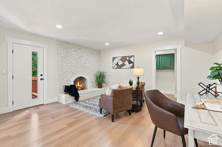 Light wood-finish flooring and a flex space could be sitting area, semi formal dining room, or den.