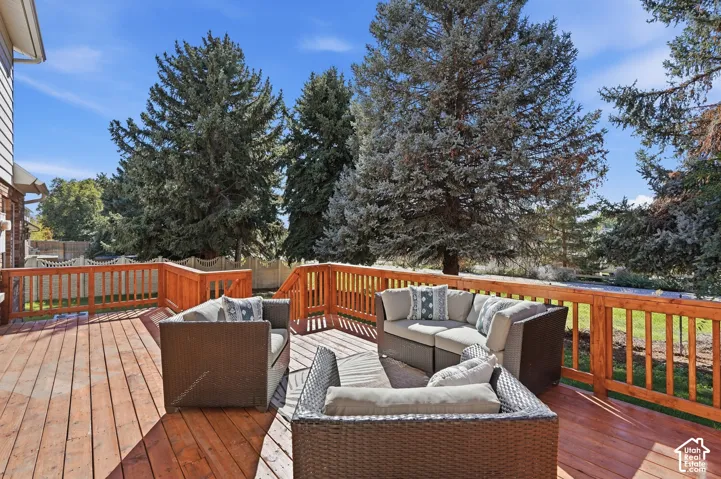 Expansive wood deck with natural wood railings, offering multiple levels and ample outdoor living space