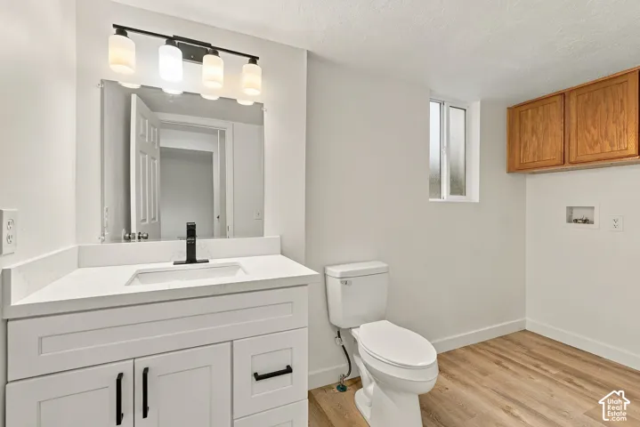 Vanity with a rectangular undermount sink, quartz countertop, and matte black faucet