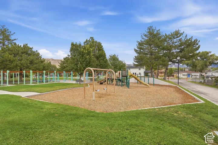 Community playground with swings, slides, and wood chip surfacing