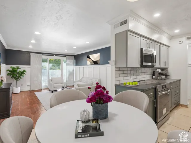 Open-concept living area featuring wood-finish flooring, recessed lighting, and sliding glass doors