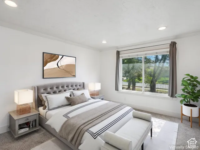 Recessed lighting, crown molding, and a large window with roller shades