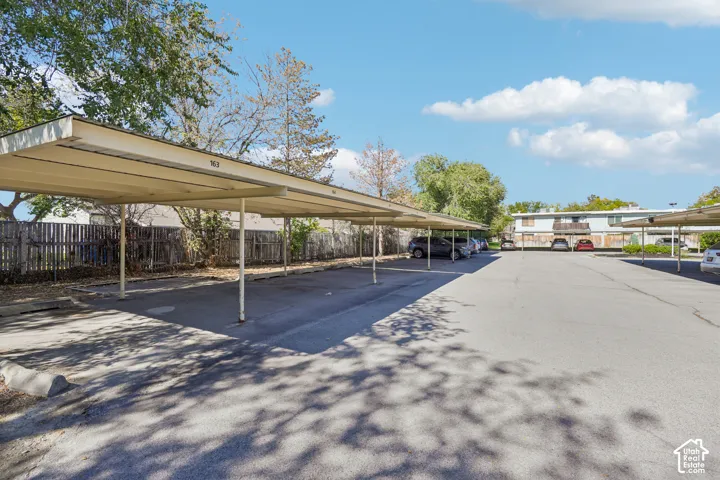 Covered parking spaces with asphalt surfacing and concrete curbing