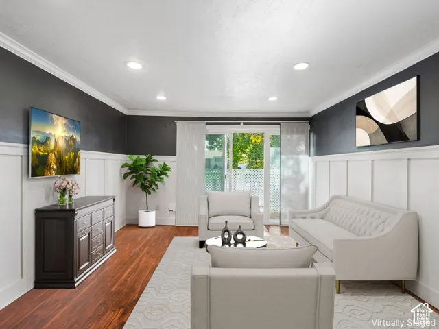White board and batten wall paneling, dark wood-finish flooring, recessed lighting, crown molding, and sliding glass doors