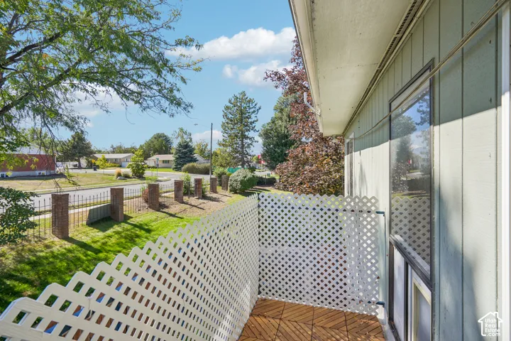 Balcony with wood-finish flooring and lattice railing