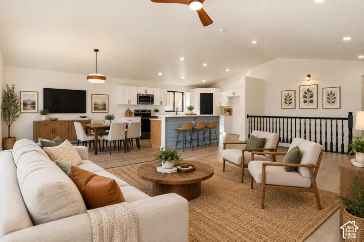 Vaulted ceiling with a ceiling fan, recessed lighting, and LVP-finish flooring throughout