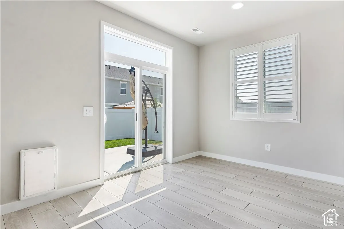 Sliding glass door leading to an outdoor patio with a concrete surface