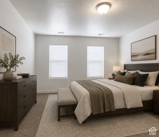 Recessed lighting, light-filtering window blinds, and neutral wall tones complement the carpeted flooring