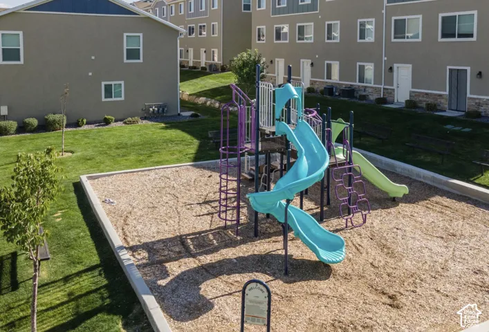 Recreational playground with multiple slides and climbing structures set on wood chip surfacing