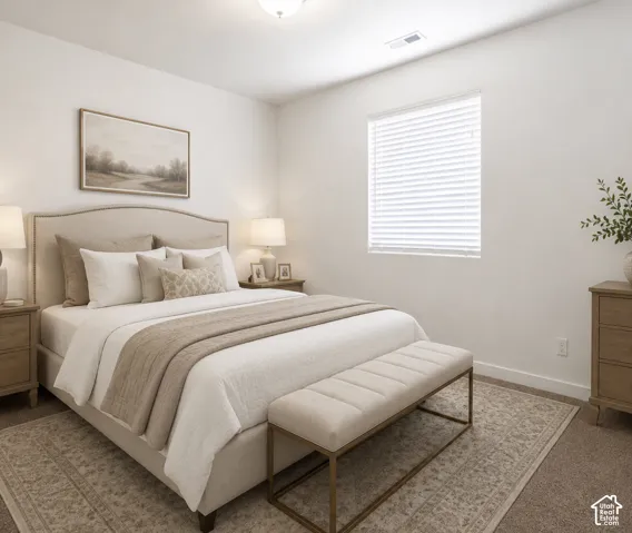 Primary bedroom featuring an upholstered headboard with nailhead trim, layered bedding in neutral tones, wood-finish nightstands with integrated lighting, a geometric area rug, and abundant natural light from a large window with horizontal blinds
