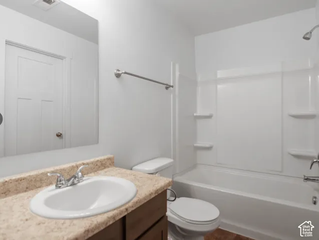 White bathtub and shower combination with integrated shelving