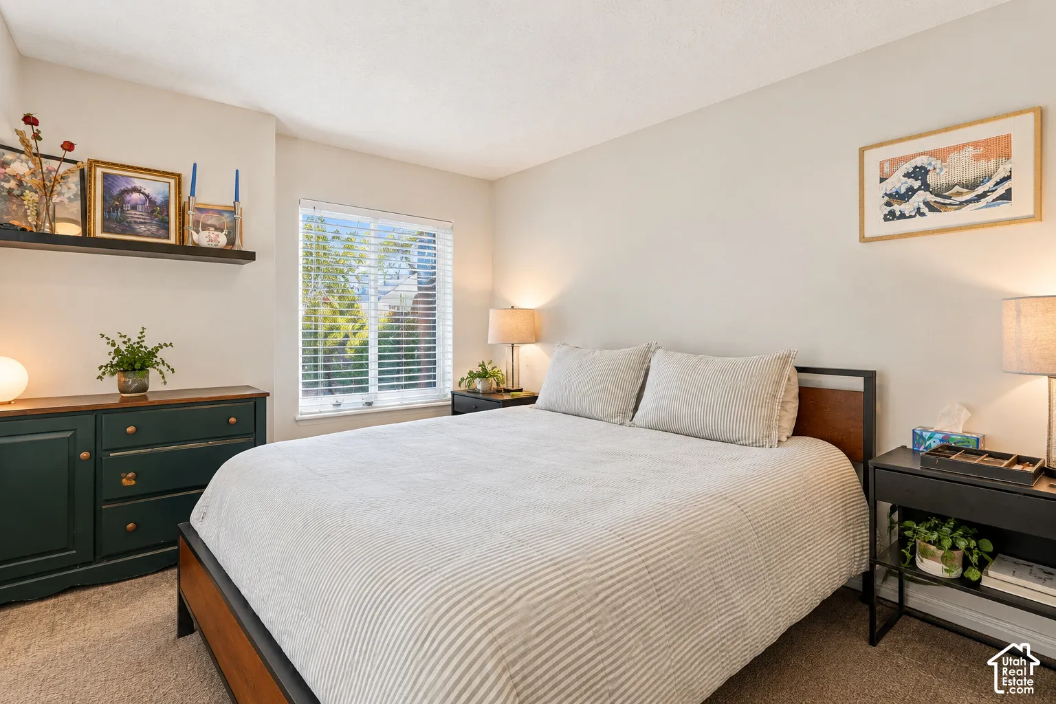 Recessed window with blinds, wood-finish bed frame, built-in floating shelf, and neutral wall color