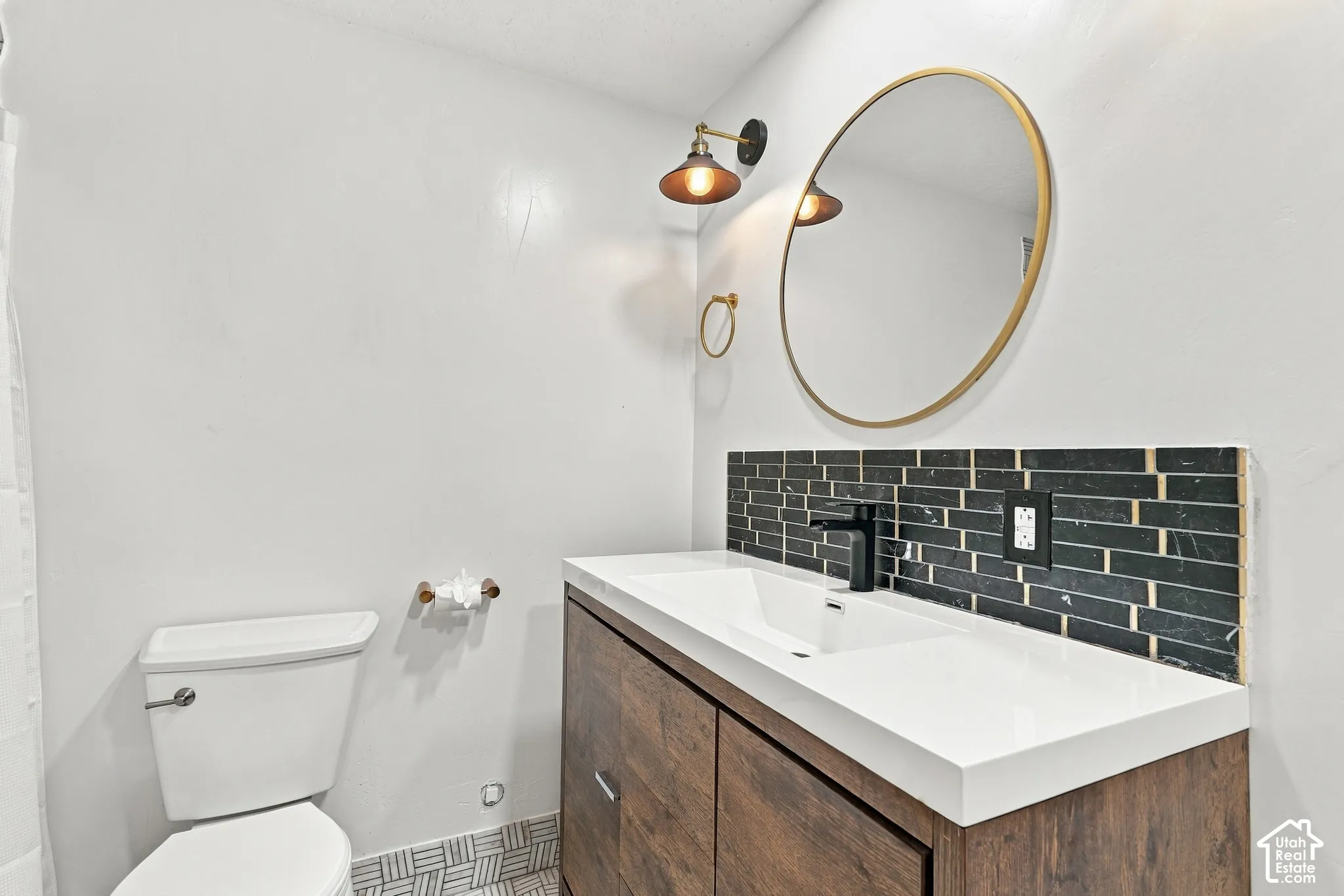 Wood-finish vanity with an integrated rectangular sink and a matte black faucet