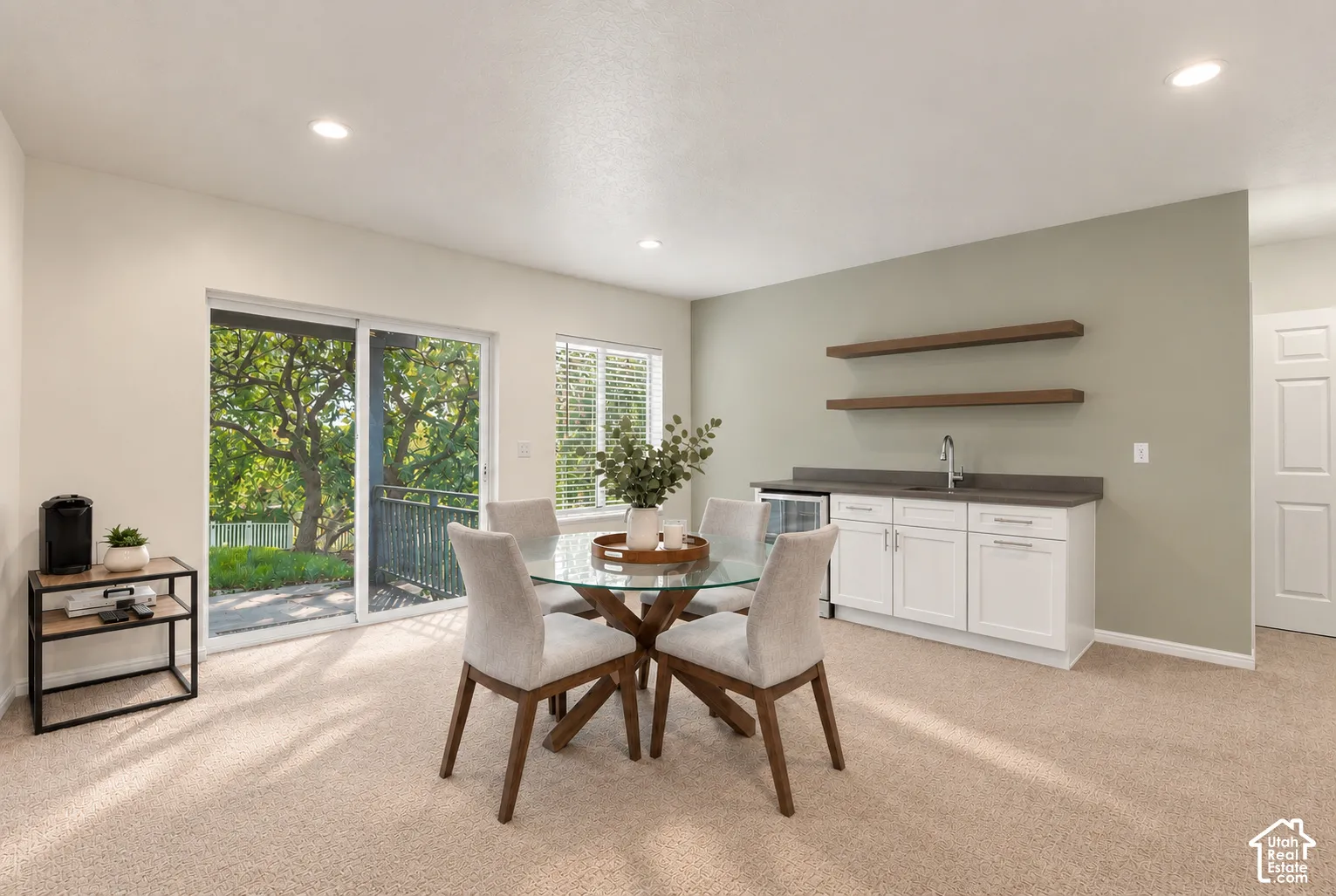 Built-in wet bar with white cabinetry, dark countertop, and integrated beverage refrigerator