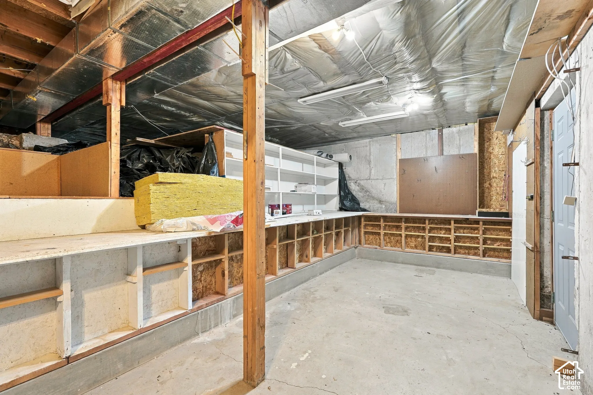 Concrete flooring with extensive built-in shelving and workbench space