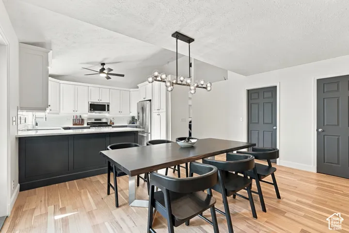 Kitchen with two-tone cabinetry, stainless steel appliances, and a white subway tile backsplash