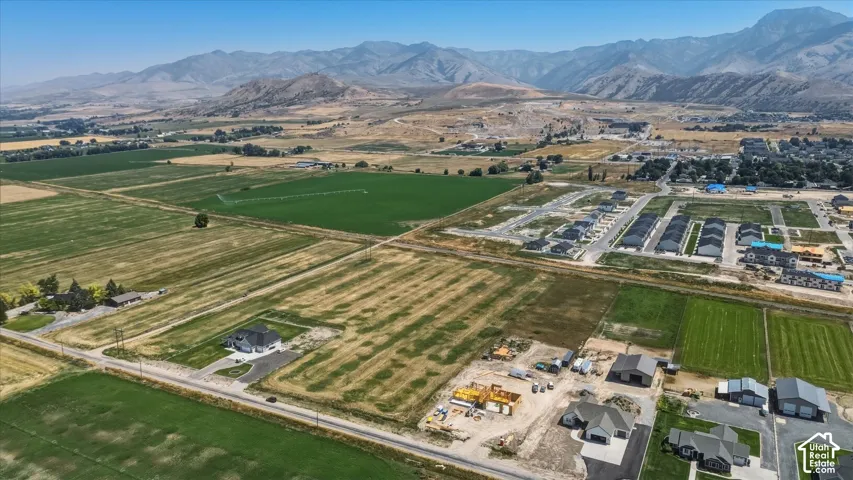 Expansive land parcel with surrounding agricultural fields and distant mountain ranges