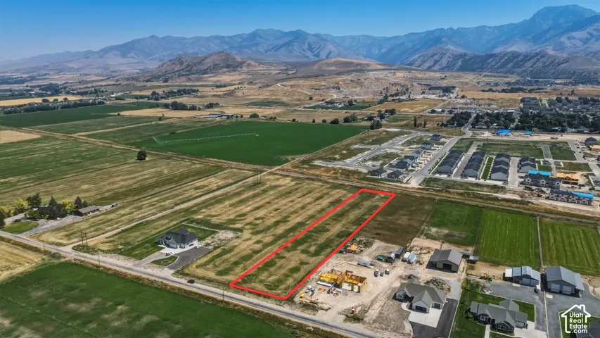 Expansive land parcel featuring open fields and distant mountain ranges