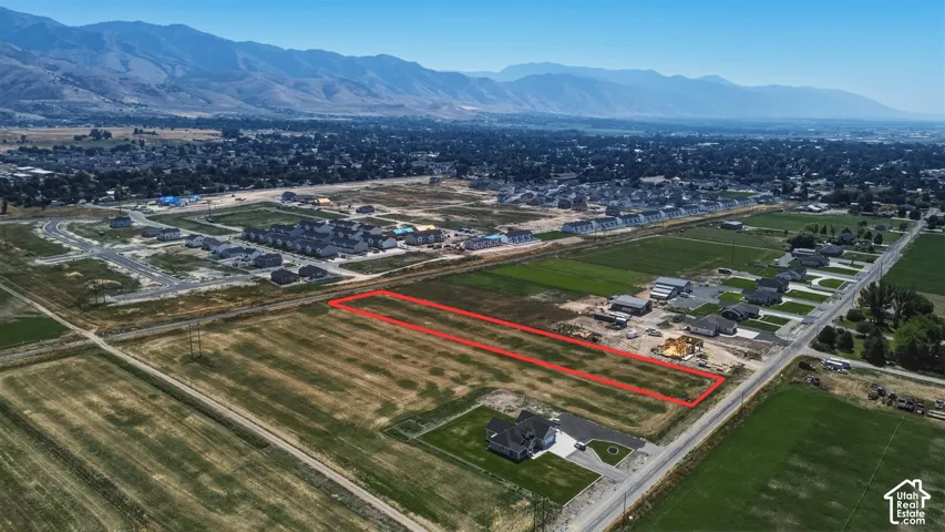 Expansive land parcel outlined in red, featuring a flat, cleared terrain