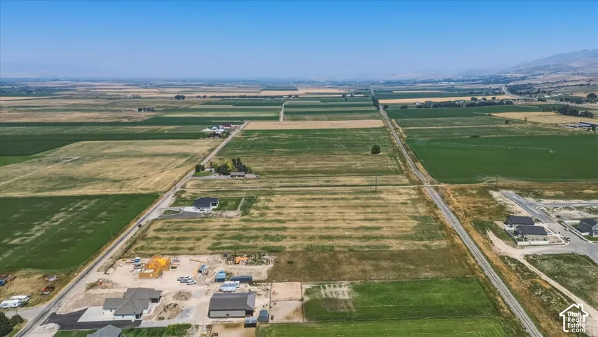Expansive agricultural fields with scattered residential properties