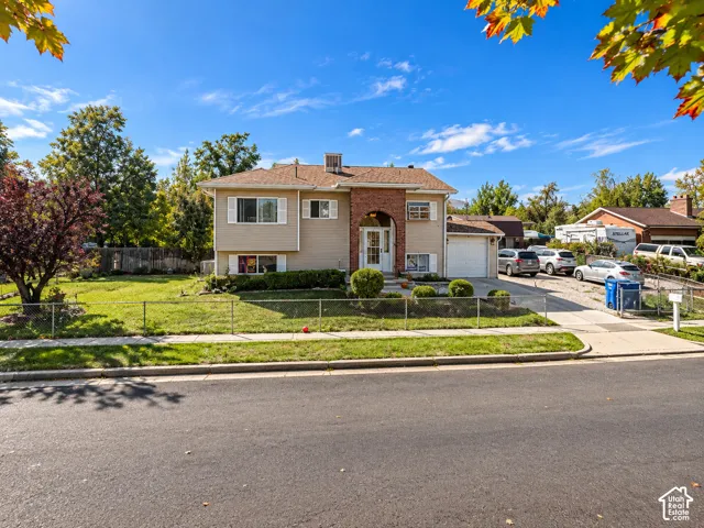 Two-story residence with brick accents, an attached garage, and a long driveway