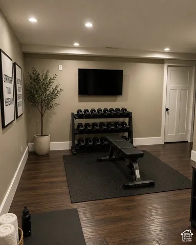 Recessed ceiling lighting, wood-finish flooring, and a white paneled door