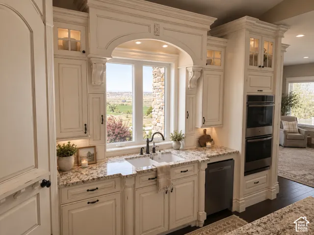 White cabinetry with decorative molding and glass-front upper cabinets