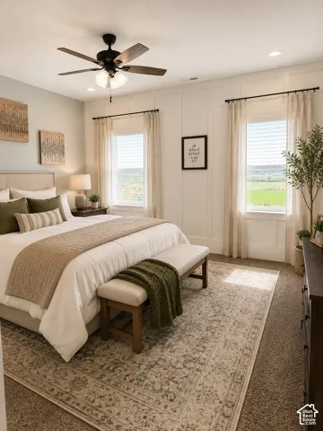 Recessed lighting, ceiling fan with light fixture, two windows with blinds and drapes, and paneled accent wall