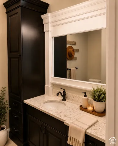 Dark wood-finish vanity with an integrated sink, light-colored speckled countertop, and a dark bronze faucet