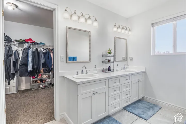 Dual-sink vanity with white cabinetry, brushed nickel hardware, and white quartz countertops