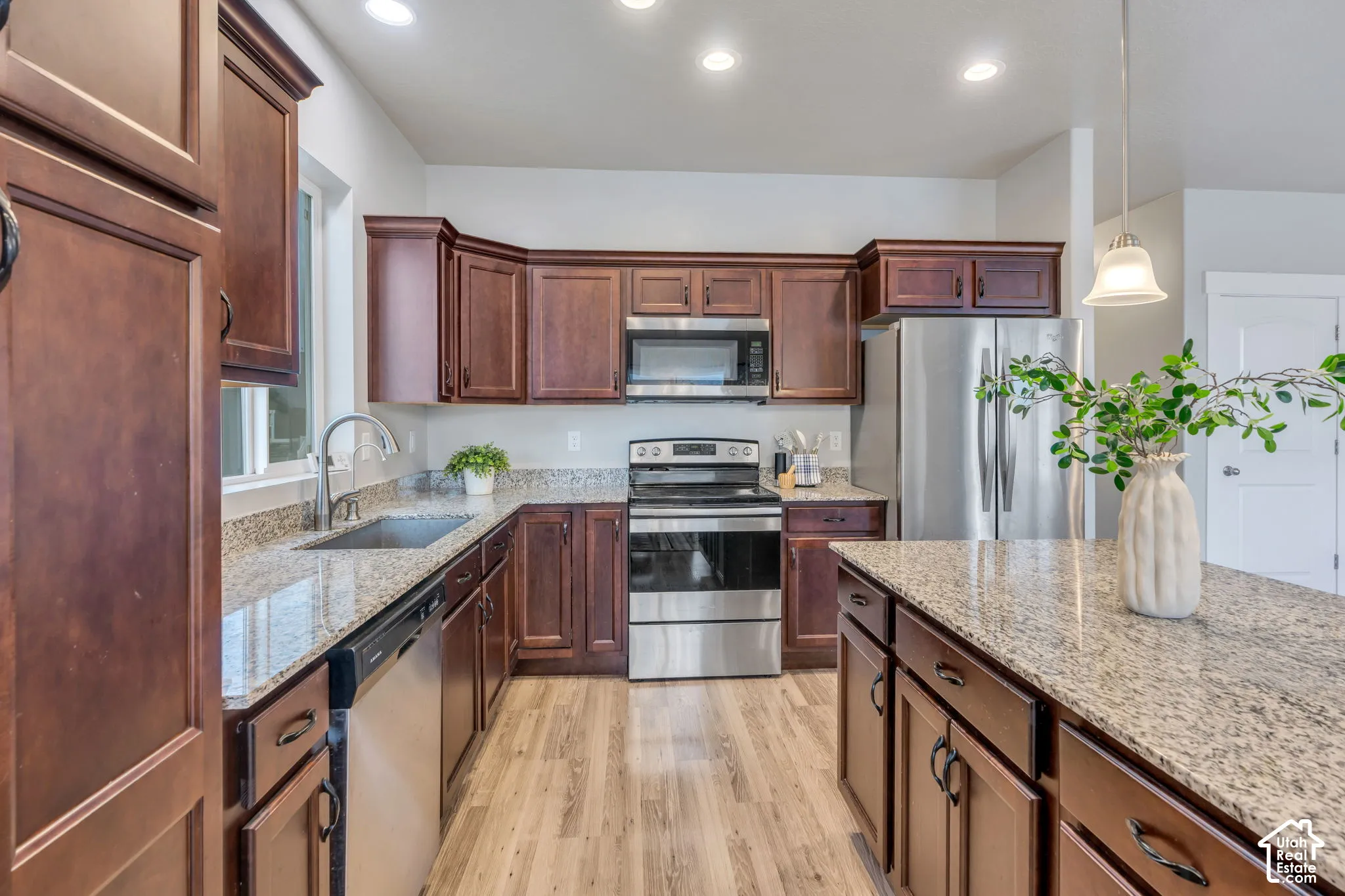 Kitchen featuring wood-finish flooring, recessed lighting, and granite countertops
