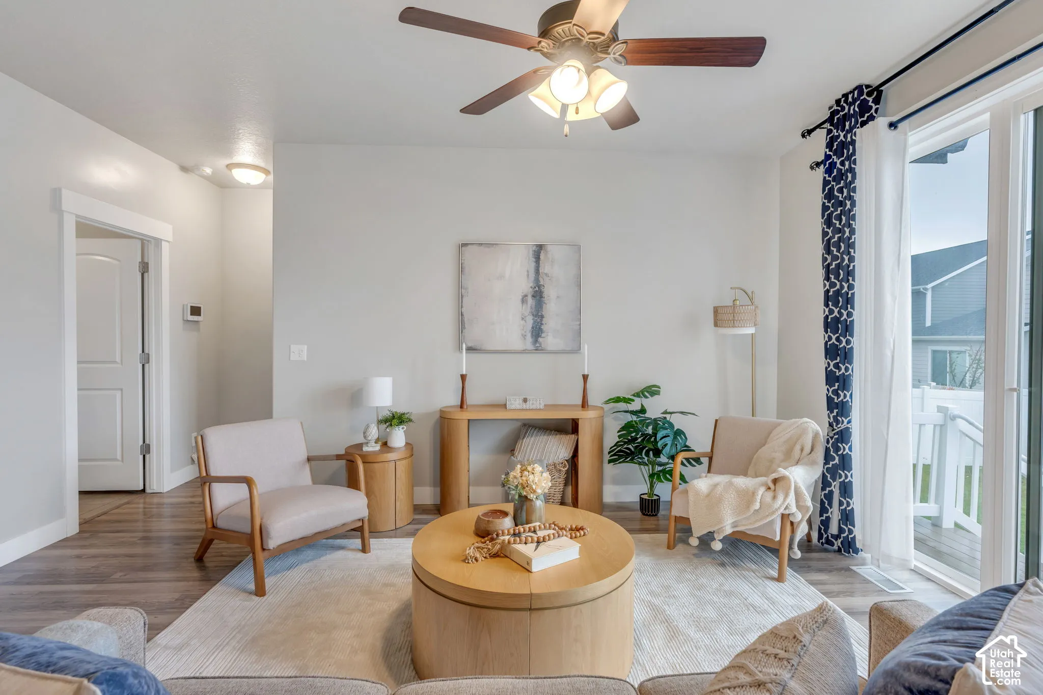 Recessed lighting, wood-finish flooring, ceiling fan with integrated lighting, white interior door, and sliding glass door