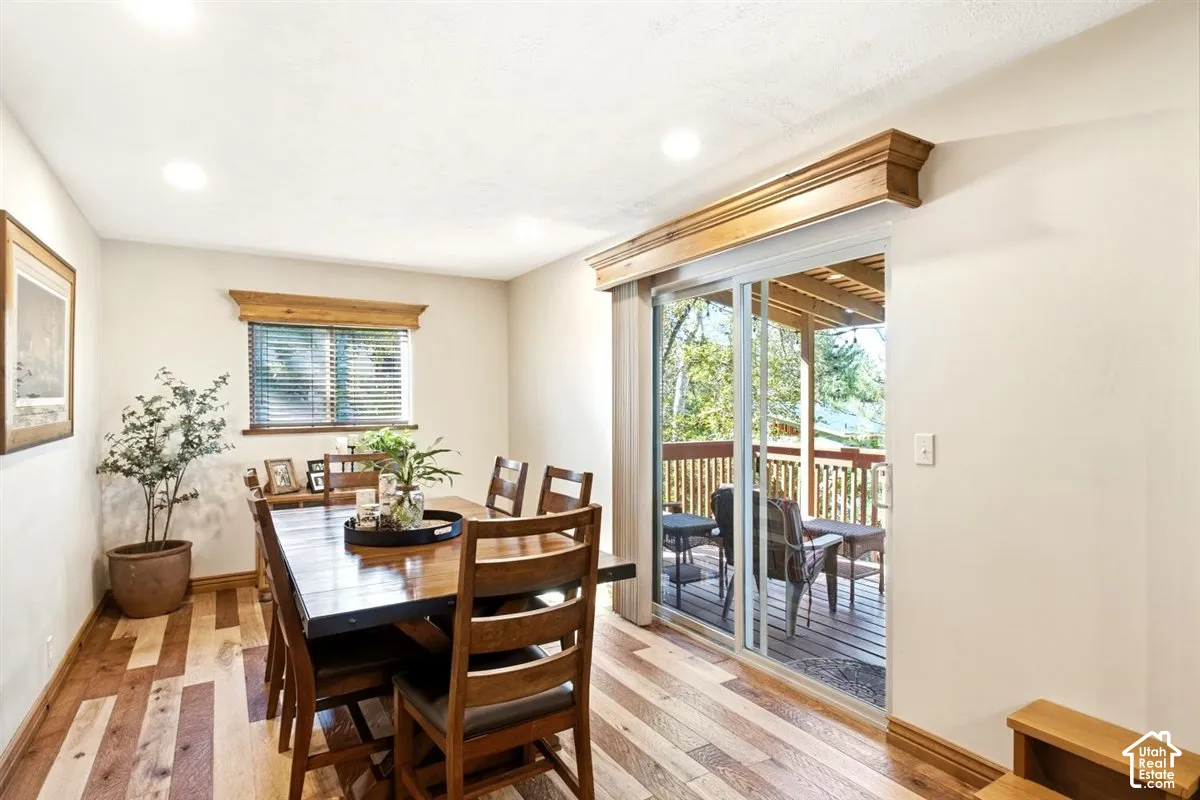Wood-finish flooring, recessed lighting, wood window trim, wood cornices, and a sliding glass door