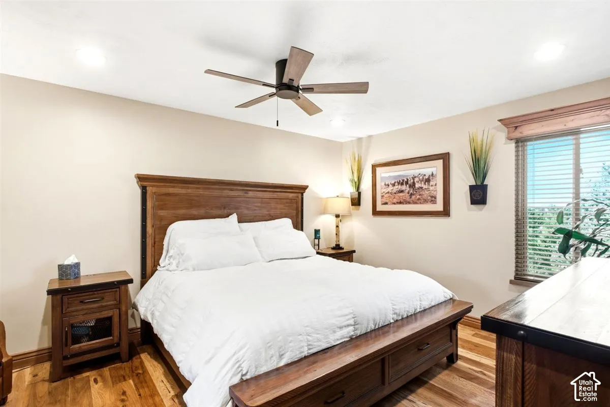 Wood-finish flooring, recessed lighting, and a ceiling fan