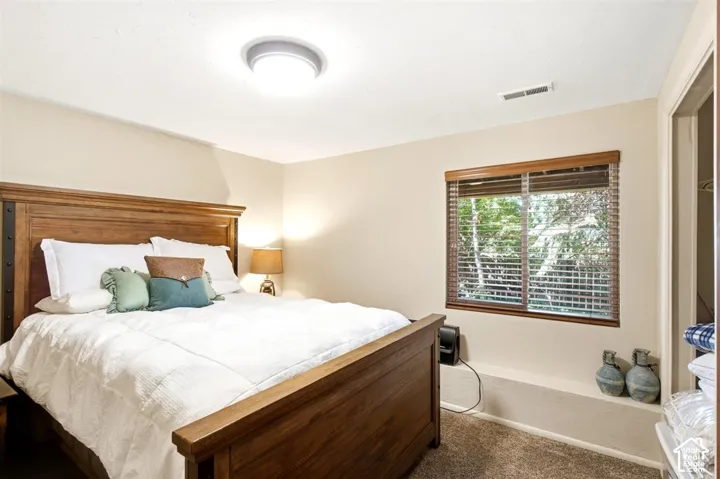 Recessed window with wood-finish blinds, light beige wall paint, textured ceiling, and flush-mount ceiling light