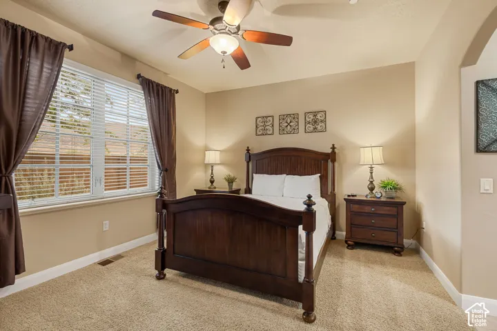 Carpet flooring, ceiling fan with integrated lighting, window with blinds, and neutral wall tones